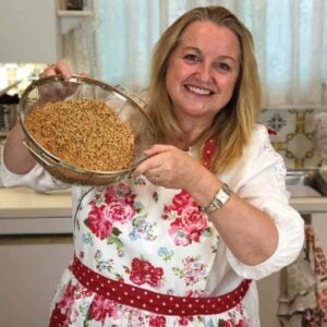 Mary's Nest in her kitchen with a bowl of sprouted grains in her hands.