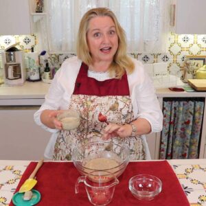 YouTube thumbnail of Mary behind a bowl of sour dough starter and a small bowl of it in her hand.