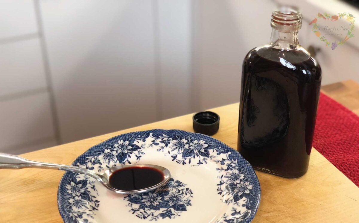 A bottle of Elderberry Syrup with spoon.