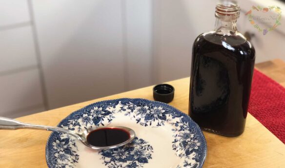 Bottle of Elderberry Syrup with spoon.