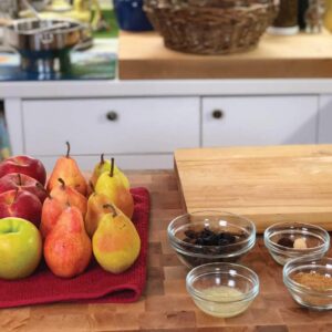 Apples, Pears, and additional ingredients on a cutting board