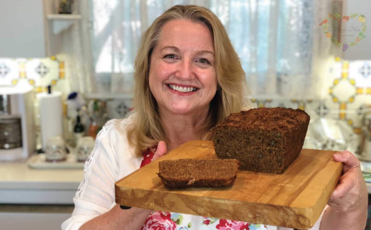 Mary holding cutting board with Cinnamon Crunch Banana Bread baked with Sprouted Flour.