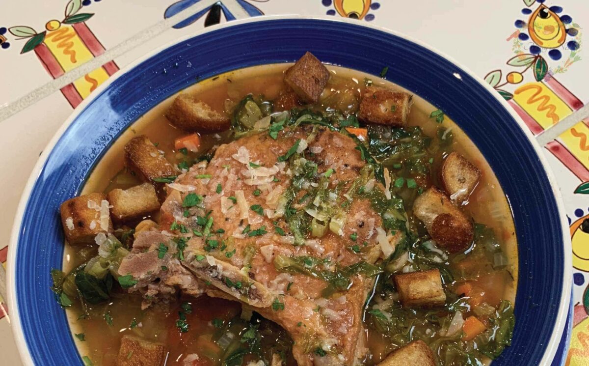 A bowl of chickpea and pork rib soup on the table.