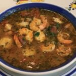 Italian fish stew called Cioppino in a bowl on the table.