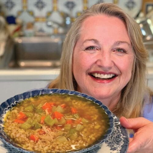 Mary's holds a bowl of chicken soup that was made with bone broth.