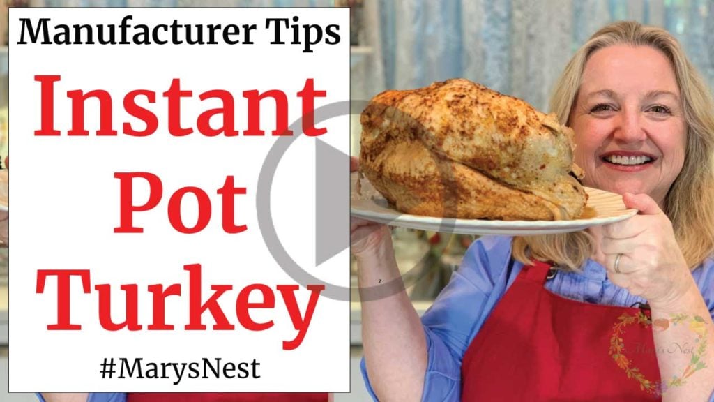 Mary holding a cooked turkey from an Instant Pot.