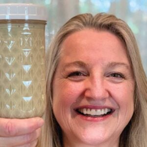 Mary holding a jar of evaporated milk.