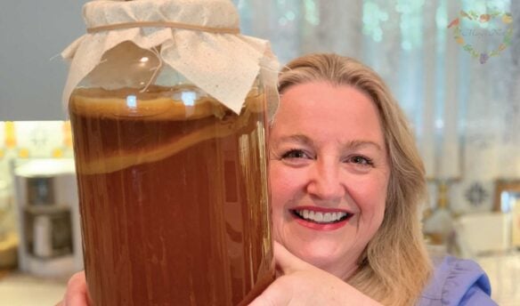 Mary holding a jar with a Kombucha SCOBY.