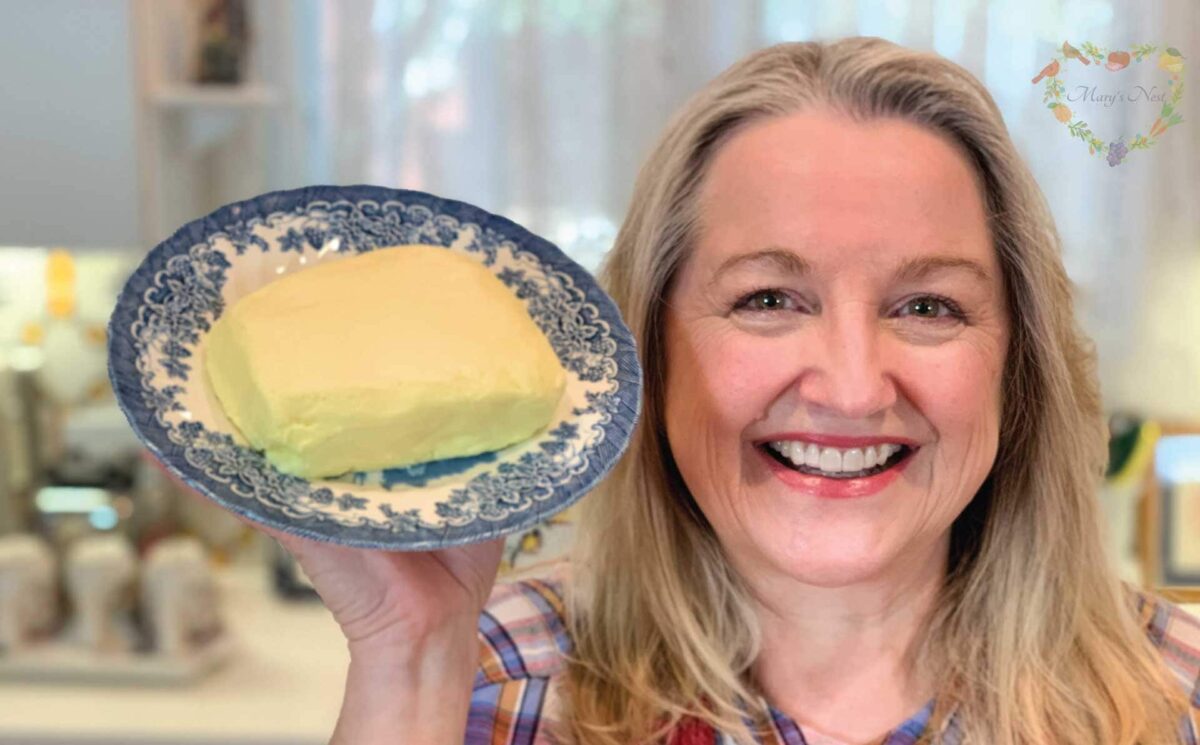 Mary holding a plate with homemade butter.