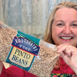Mary holding a bag of pinto beans.