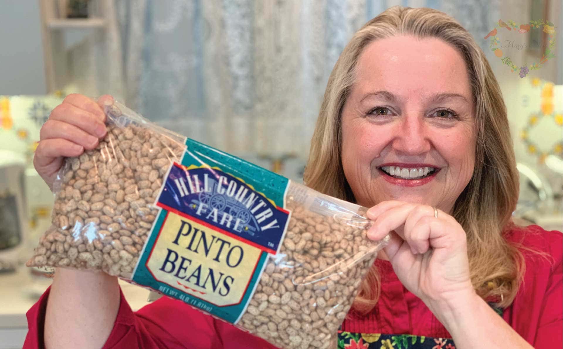 Mary holding a bag of pinto beans.