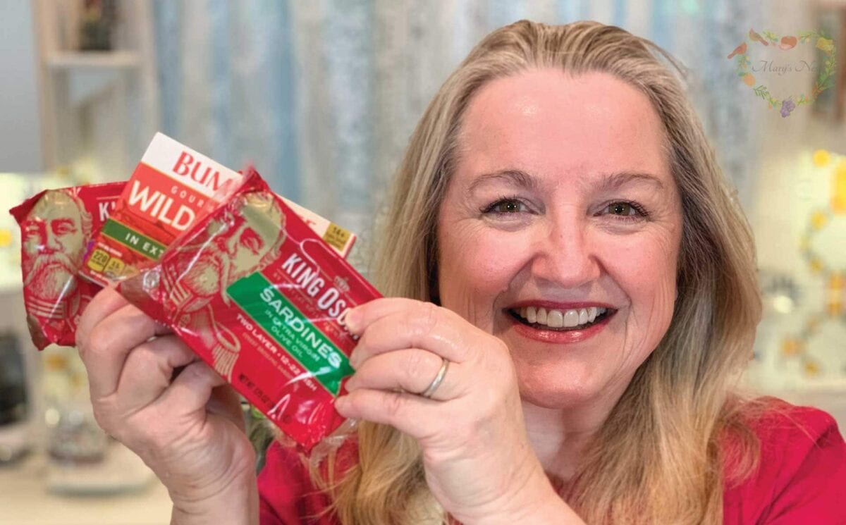 Mary holding a variety of canned sardines.