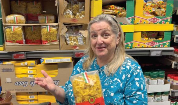 Mary showing a bargain-priced bag of pasta.