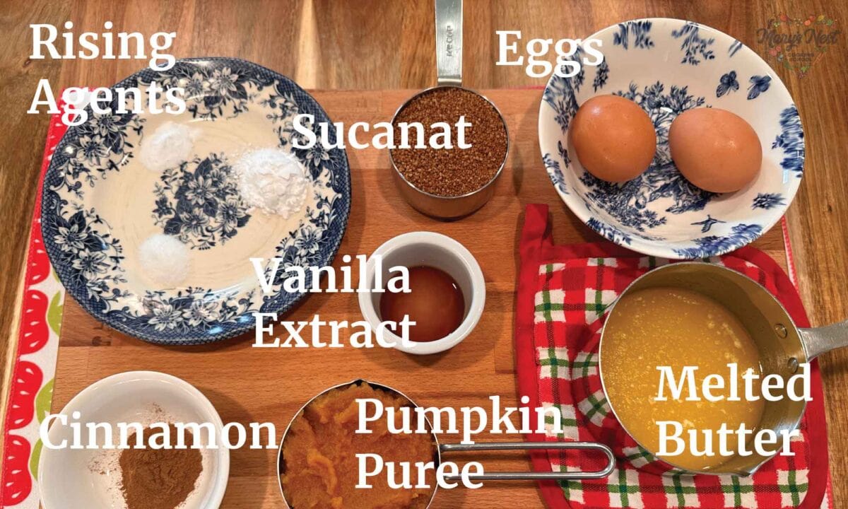 Soaked Flour Muffin Ingredients showing rising agents, eggs, sucanat, cinnamon, vanilla extract, and pumpkin puree.